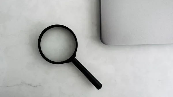 Is your website ready for AI search — magnifying glass and laptop