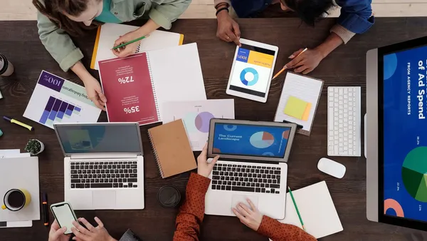 A marketing performance and ad-spend report laid out on a desk — the reporting an outsourced marketing department delivers each month