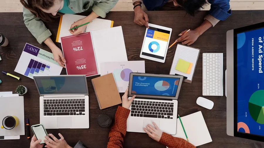 A marketing performance and ad-spend report laid out on a desk — the reporting an outsourced marketing department delivers each month