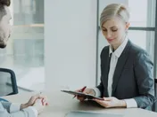 Small business owner and marketing consultant reviewing options in a focused business meeting