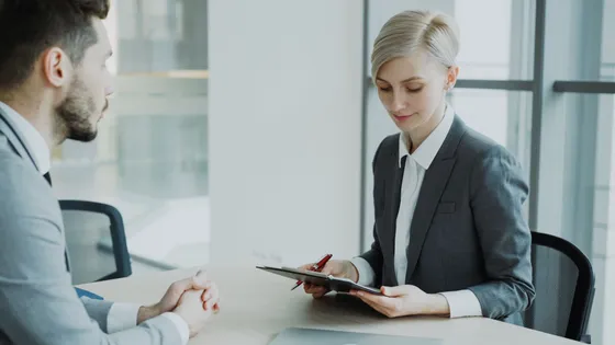 Small business owner and marketing consultant reviewing options in a focused business meeting