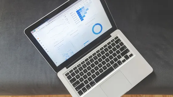 Overhead view of a laptop showing marketing analytics dashboard with charts and data visualisations