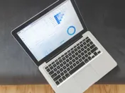 Overhead view of a laptop showing marketing analytics dashboard with charts and data visualisations