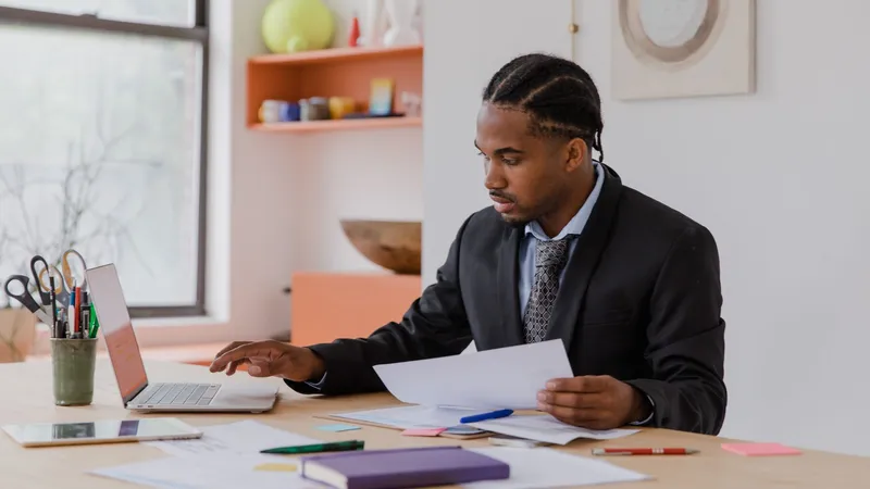 Small business owner comparing an AI marketing tool dashboard against a done-for-you managed marketing service