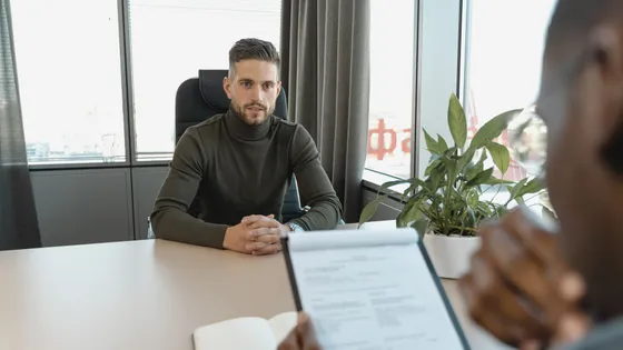 Startup founder weighing a fractional CMO against a done-for-you managed marketing service that handles both strategy and execution