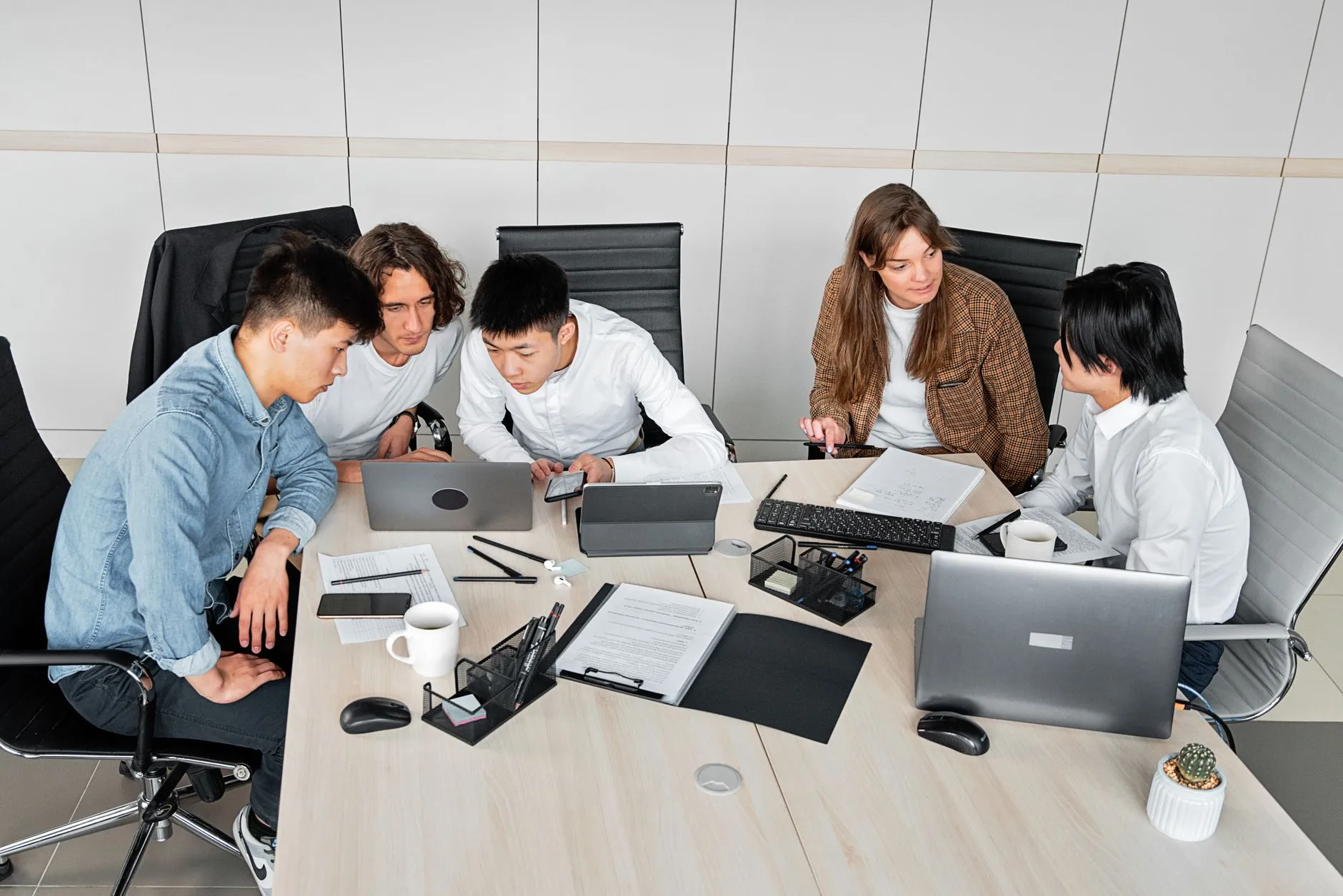 Colleagues reviewing digital campaign results on a laptop in a modern office setting