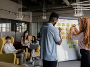 A startup team mapping priorities on a whiteboard, narrowing focus to the vital few activities that drive most of the results