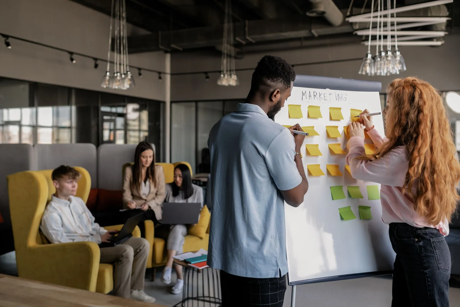 Marketing team planning strategy together in a modern office, the kind of collaborative, integrated team a managed service provides