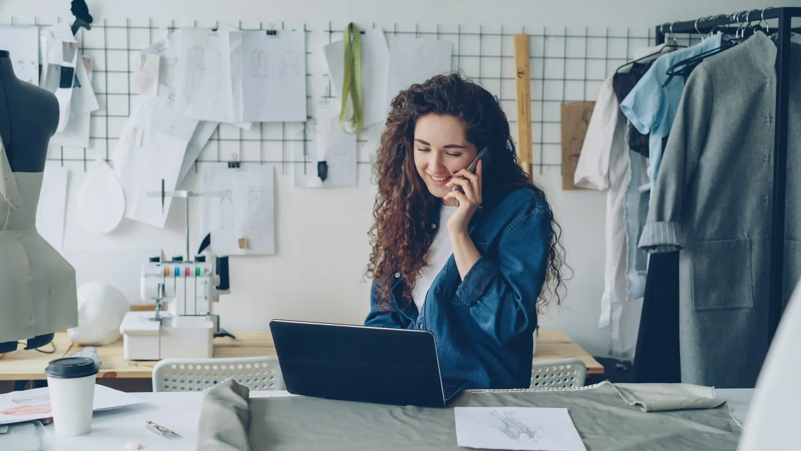 A small business owner working on a laptop in their shop — the founder wearing the marketing hat before hiring an agency
